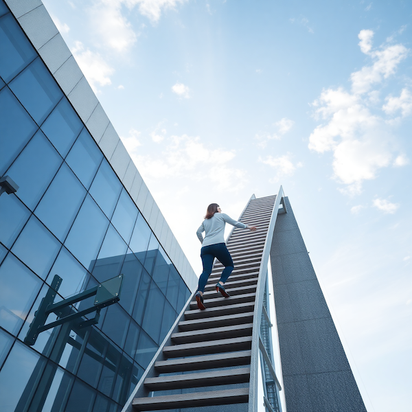 Professional woman climbing a staircase representing growth